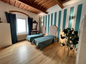 a room with blue and white stripes on the walls at Turchese Suite in Pisa
