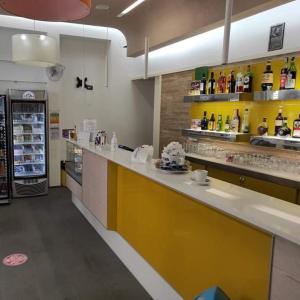 a kitchen with a yellow counter in a store at HOTEL HOUSE GARGANO in San Giovanni Rotondo