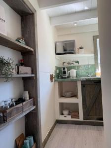 a room with a kitchen with wooden shelves at Meerpaal 43 Bergen in Bergen +26 photos