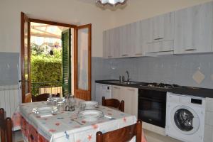 a kitchen with a table with plates on it at La Limonaia in Marciana Marina