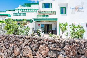 a stone wall in front of a house at Vivienda Vacacional Las Coronas 48 in Costa Teguise