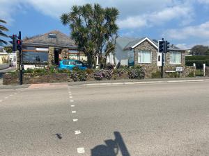 a shadow of a person taking a picture on the street at Aquarius B&B in Newquay