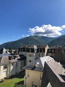 a group of buildings with mountains in the background at Le Perce Neige - plein centre in Luchon