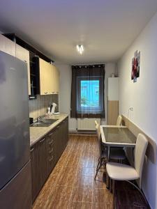 a kitchen with a table and chairs in a kitchen at Mara in Făgăraş