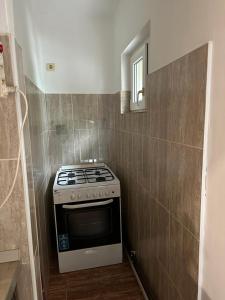 a small kitchen with a stove and a mirror at Mara in Făgăraş +8 photos