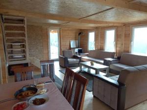 a living room with a couch and a table at Daci Guesthouse 