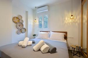 a bedroom with a bed with white pillows and a window at Ionia Living in Barbati