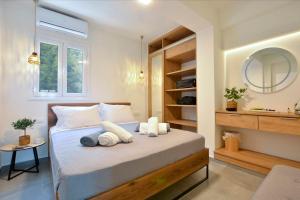 a bedroom with a bed and a mirror at Ionia Living in Barbati