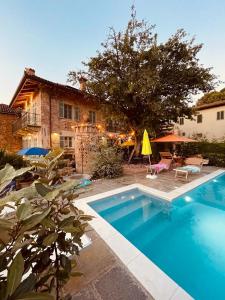 a swimming pool in front of a house at Appartamento Cico in Andezeno