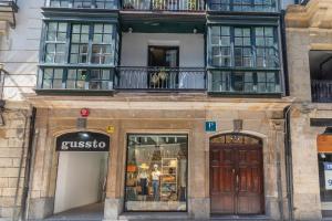 a store with a sign on the front of a building at Victorooms in Bilbao