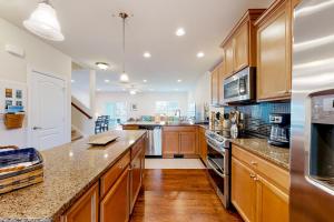 a large kitchen with wooden cabinets and a counter top at Fairway Village - 136 Augusta Dr #26 in Ocean View