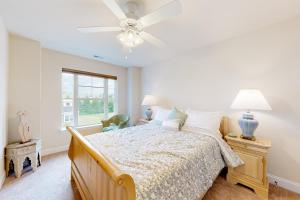 a bedroom with a bed and a ceiling fan at Fairway Village - 136 Augusta Dr #26 in Ocean View +35 photos