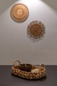 a basket on a table with other objects on a wall at Mirada Exclusive Bodrum in Bodrum City