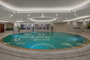 a large swimming pool in a hotel lobby at Mirada Exclusive Bodrum in Bodrum City