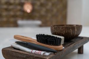 a group of brushes sitting on a wooden table at Mirada Exclusive Bodrum in Bodrum City