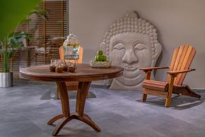 a table with a statue of a head and a chair at Mirada Exclusive Bodrum in Bodrum City