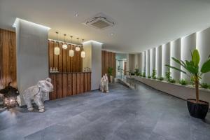 a hallway with two people in suits standing in a building at Mirada Exclusive Bodrum in Bodrum City