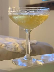 a martini glass sitting on top of a table at Tamarin & Capucin Suite Balnéo in Aubagne