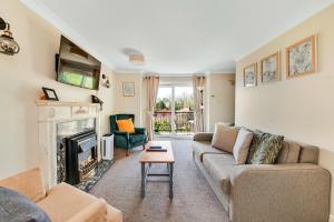 a living room with a couch and a fireplace at Finest Retreats - Bilsdale Hall Cottage in Thirsk