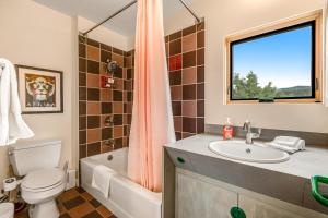 a bathroom with a sink and a toilet and a window at Paradise Place in Carbondale +41 photos