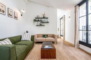 salon z zieloną kanapą i stołem w obiekcie Wonderful flat in the Marais neighbourhood - Paris - Welk w Paryżu