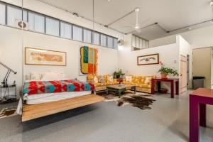 a bedroom with a bed and couches in a room at Paradise Place in Carbondale