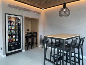 eine Küche mit einem Tisch und einem Kühlschrank mit Getränken in der Unterkunft Rentalmar Suites Salou Families Only in Salou