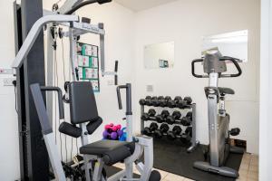 a gym with two tread machines and weights at Finest Retreats - Mowbray Hall Apt in Thirsk