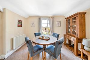 a dining room with a table and chairs and a window at Finest Retreats - Pennine Hall Apt in Thirsk