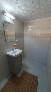 a bathroom with a sink and a mirror at Casa Razvan Vama Veche in Vama Veche