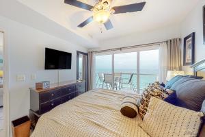 a bedroom with a bed with a view of the ocean at Emerald Isle 1105 in Pensacola Beach