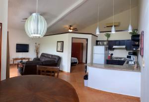 a kitchen and a living room with a table at Punta Chame Club and Resort in Chame
