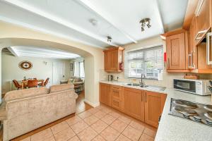 a kitchen with a couch and a table in it at Finest Retreats - Rosedale Hall Cottage in Thirsk