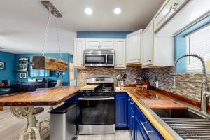 a kitchen with blue cabinets and a wooden counter top at Desert Haven Hideaway in Phoenix