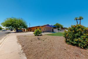 a street with a house and some bushes and trees at Desert Haven Hideaway in Phoenix