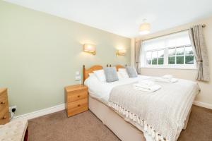 a bedroom with a bed and a window at Finest Retreats - Swaledale Hall Cottage in Thirsk