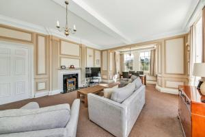 a living room with two couches and a fireplace at Finest Retreats - Sutton Hall Apt in Thirsk