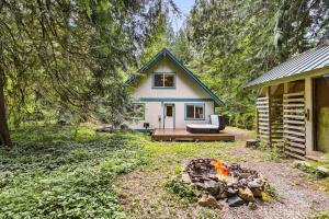 a small house with a fire in front of it at Sky One in Skykomish