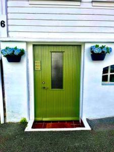 a green door on the side of a house at The Green Door H1 in Stavanger