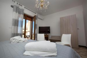 a bedroom with a bed with white towels on it at Al Centro in Gangi