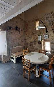 a dining room with a table and chairs and a couch at A Staccia in Ragusa