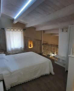 a bedroom with a white bed and a window at A Staccia in Ragusa
