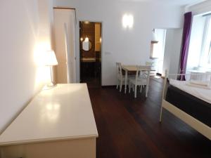 a living room with a bed and a table and a dining room at Apartment Keymaster's Hideaway in Ljubljana