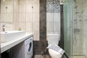 a bathroom with a toilet and a sink and a shower at Olimpias Nest Corfu in Corfu +22 photos
