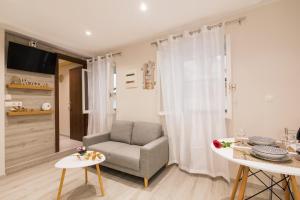 a living room with a chair and a table at Olimpias Nest Corfu in Corfu