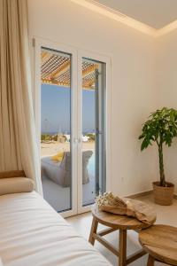 a bedroom with a bed and a view of the beach at Aya Sofia Suites in Mýkonos City