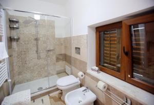 a bathroom with a shower and a toilet and a sink at Al Centro in Gangi