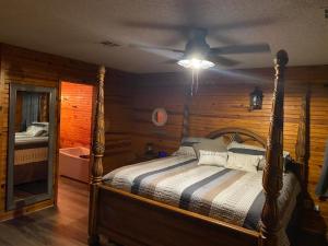 a bedroom with a bed and a ceiling fan at Off the Hook in Eufaula