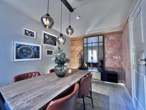 a dining room with a wooden table and chairs at The Green Door H2 in Stavanger