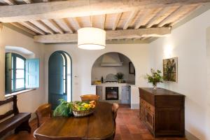 a kitchen and dining room with a wooden table at Borgo Pignano in Pignano